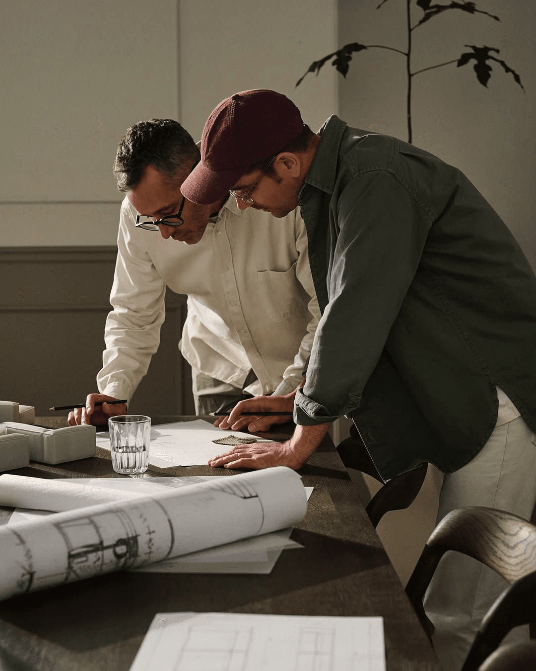 Designer and contractor reviewing plans together